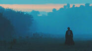 mr darcy from pride and prejudice (2005) walking across a field towards the viewer.